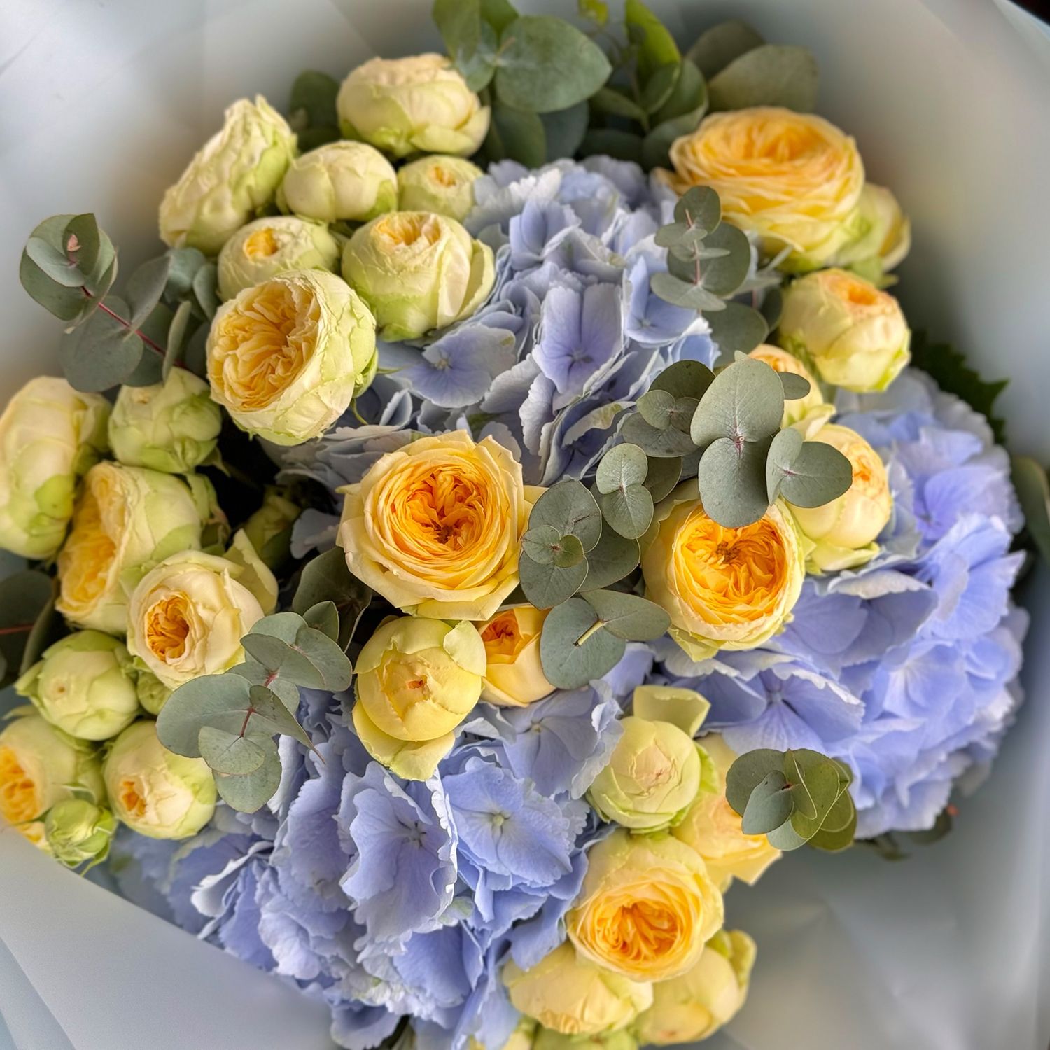 Blue hydrangea and yellow roses
